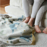 nidito Babydecke mit Dinosaurier-Motiv in grün, mint, blau, beige